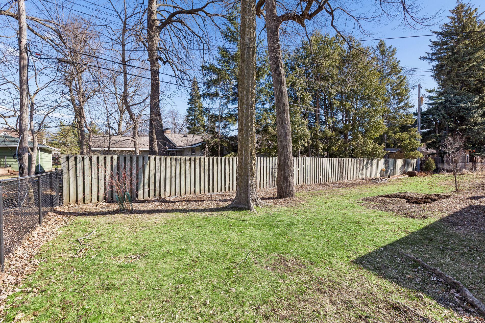 The yard is partially fenced.