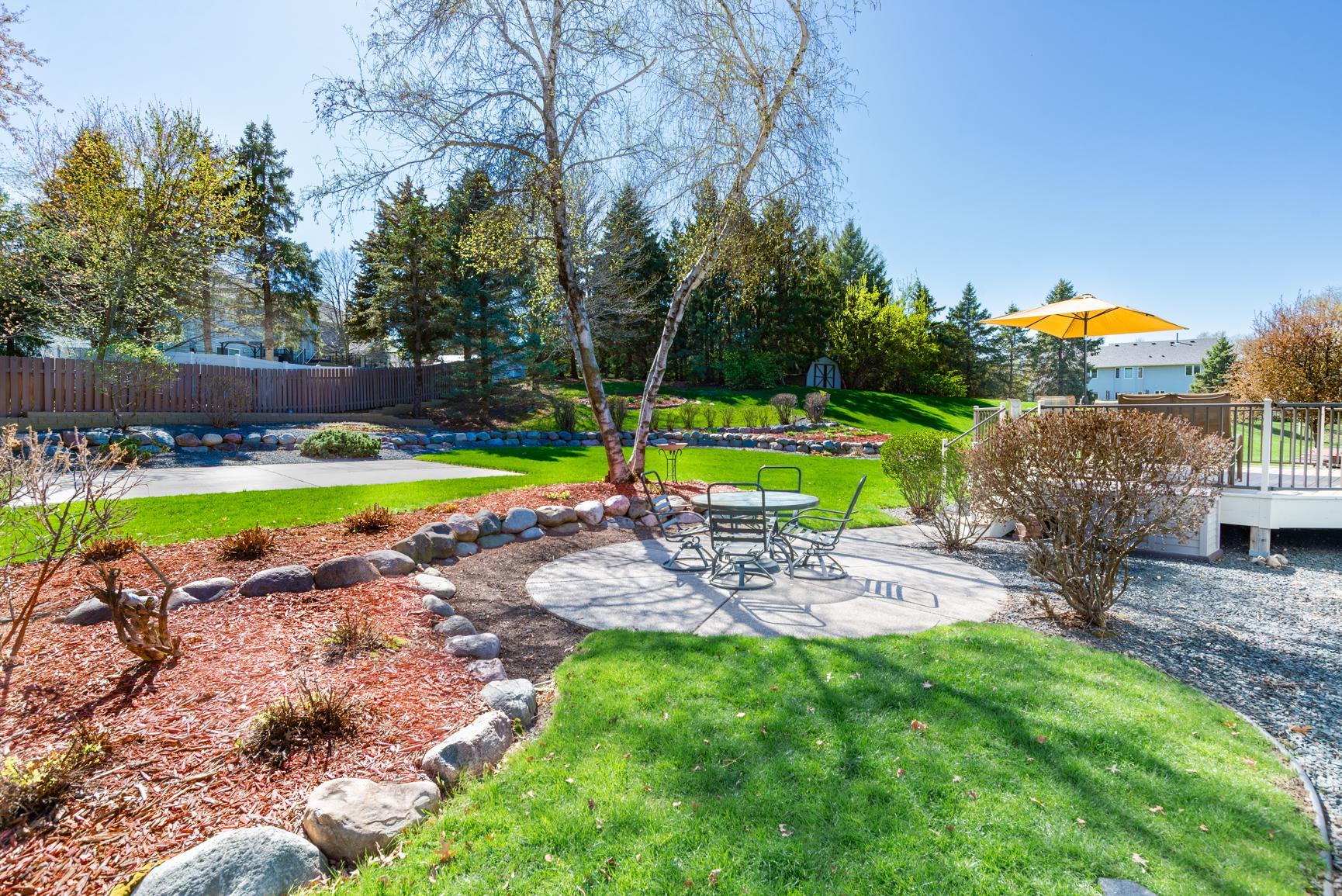 Thoughtful design of the curved lines in the landscaping and patio adds charm and ease when it comes time to mow.