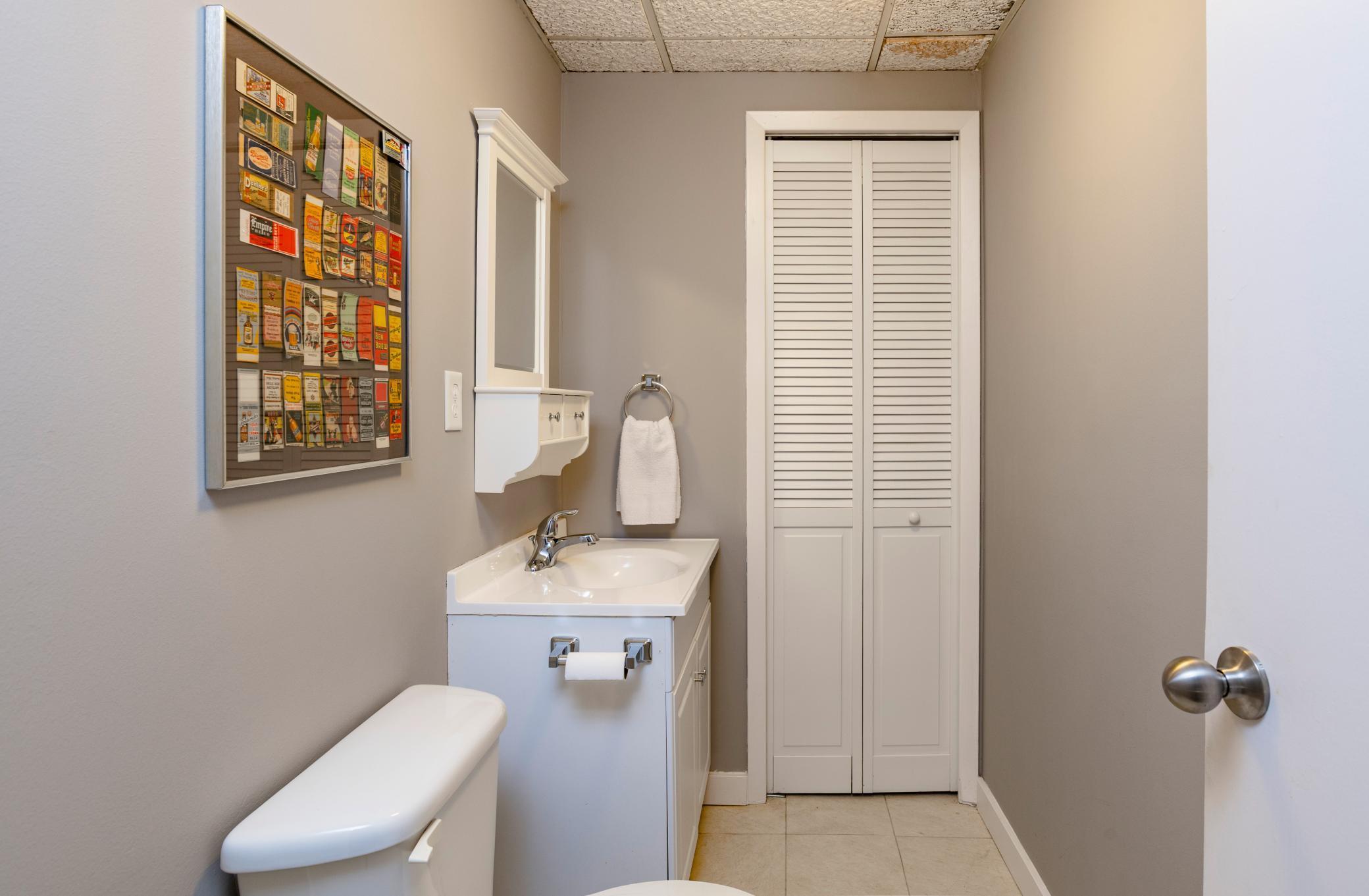 Lower level 1/2 bath with storage closet.