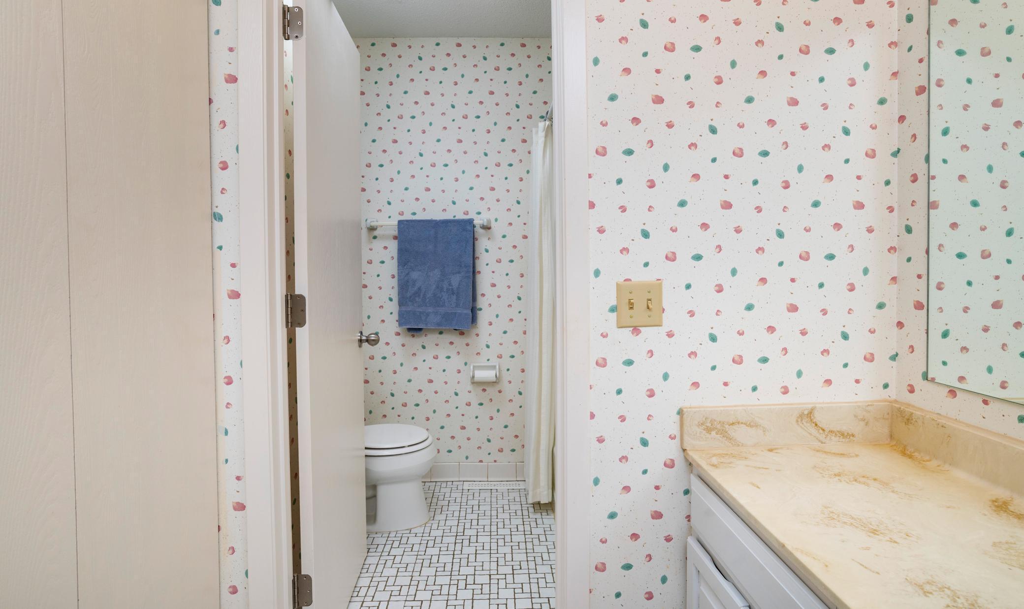 The upper level main hallway bath has a separate commode and tub/shower combo.