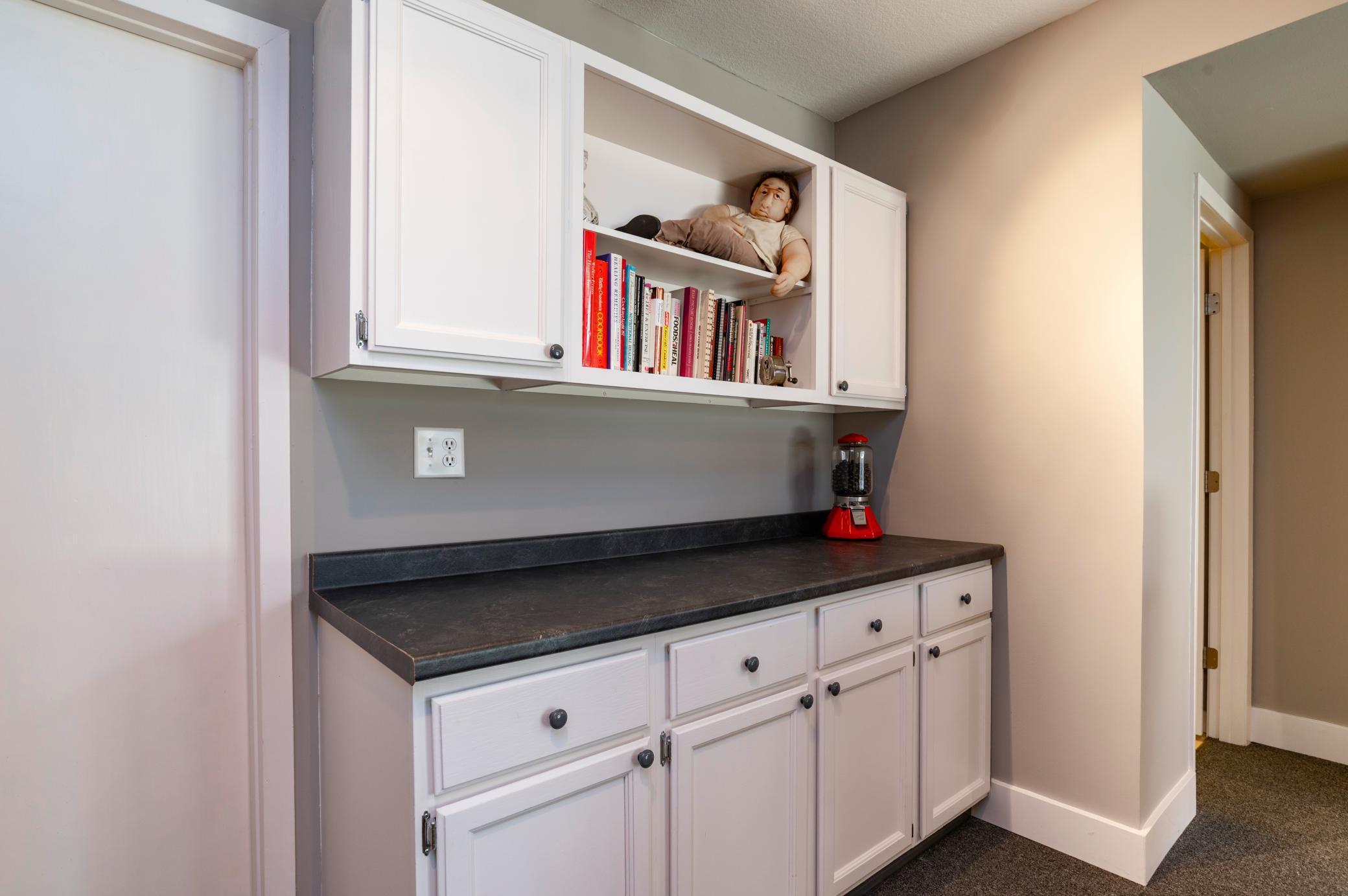The lower level features built in storage and shelving and could be used as a hobby or craft area or third Bedroom.