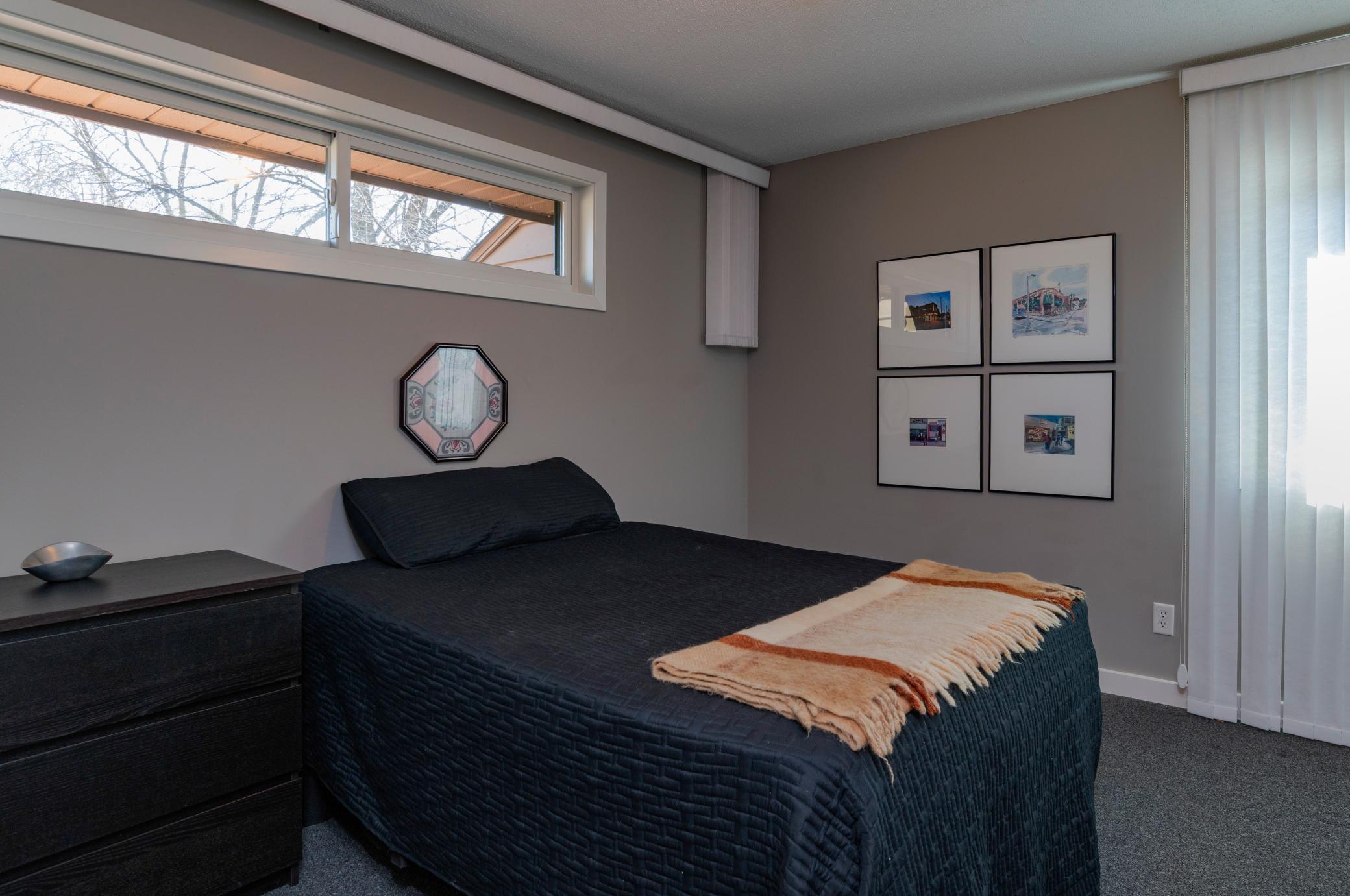 The upper floor second bedroom with two windows and large closet