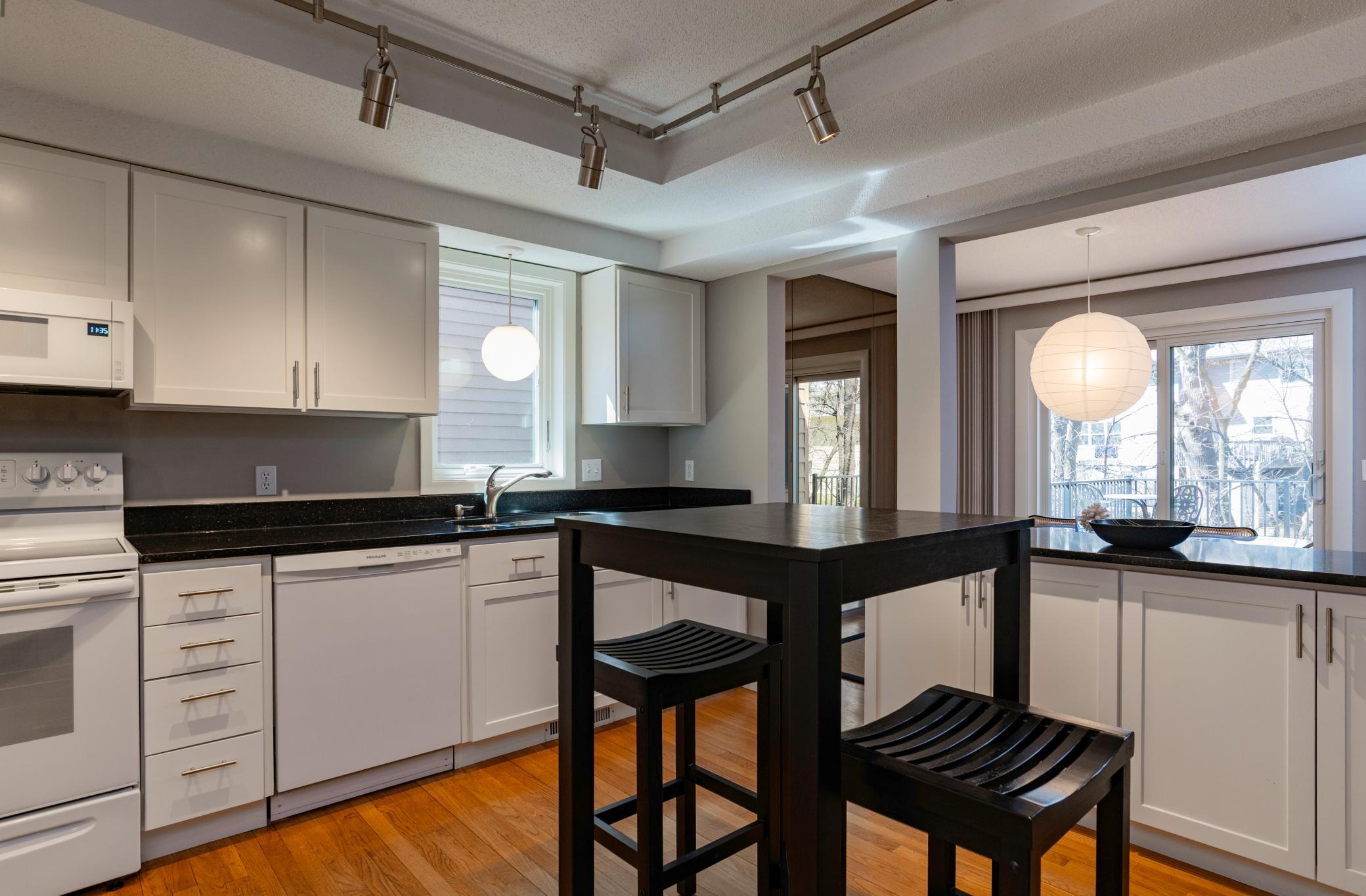 Eat in kitchen with west facing window, and hard service tops.