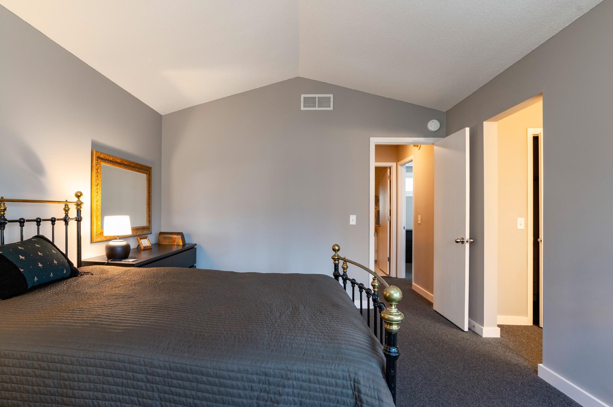 Primary Suite with doorway to upper level hall and staircase.,