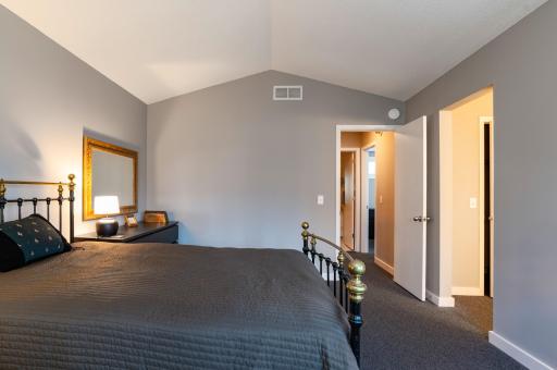 Primary Suite with doorway to upper level hall and staircase.,