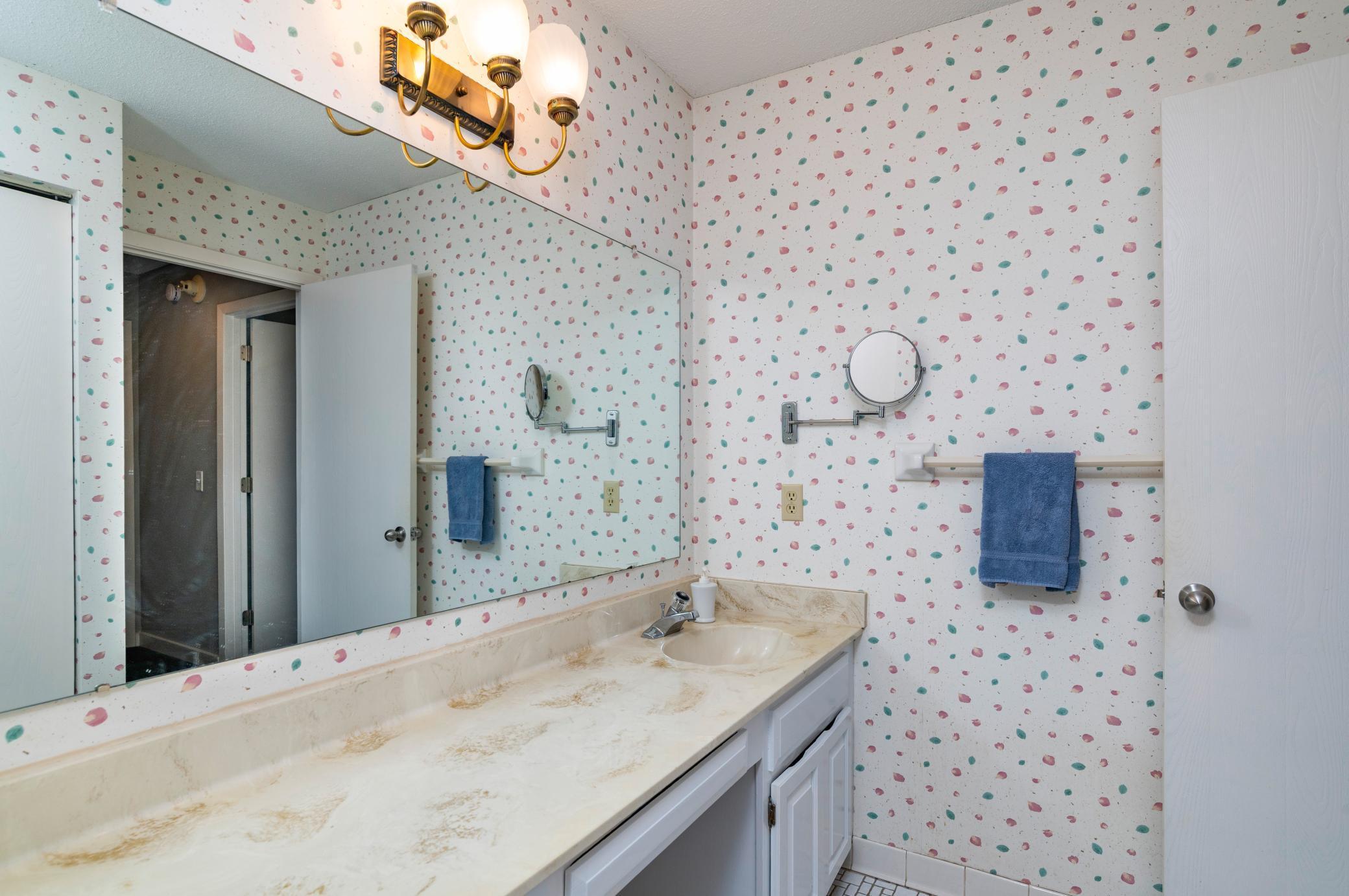 The upper floor main bath has large vanity and closet.