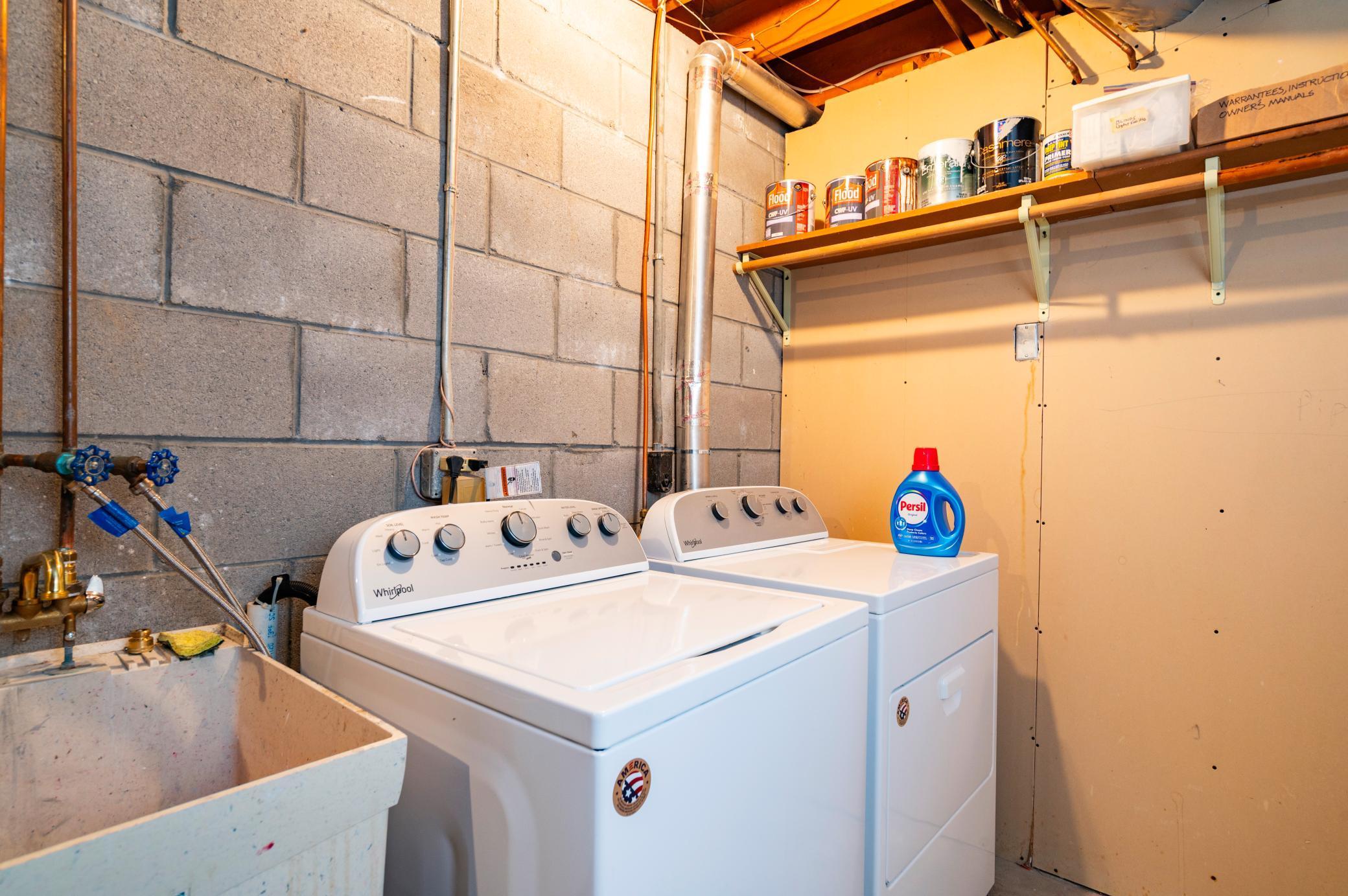 Lower level laundry and utility/mechanical room with enough room for storage.