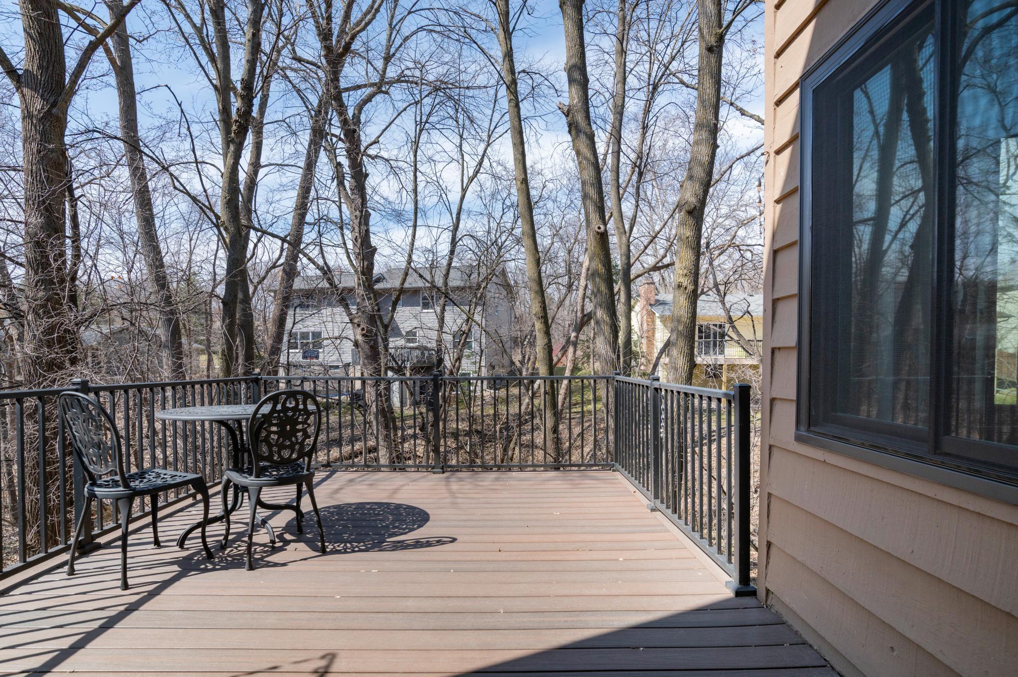 Large deck with newer composite decking and aluminum railing.