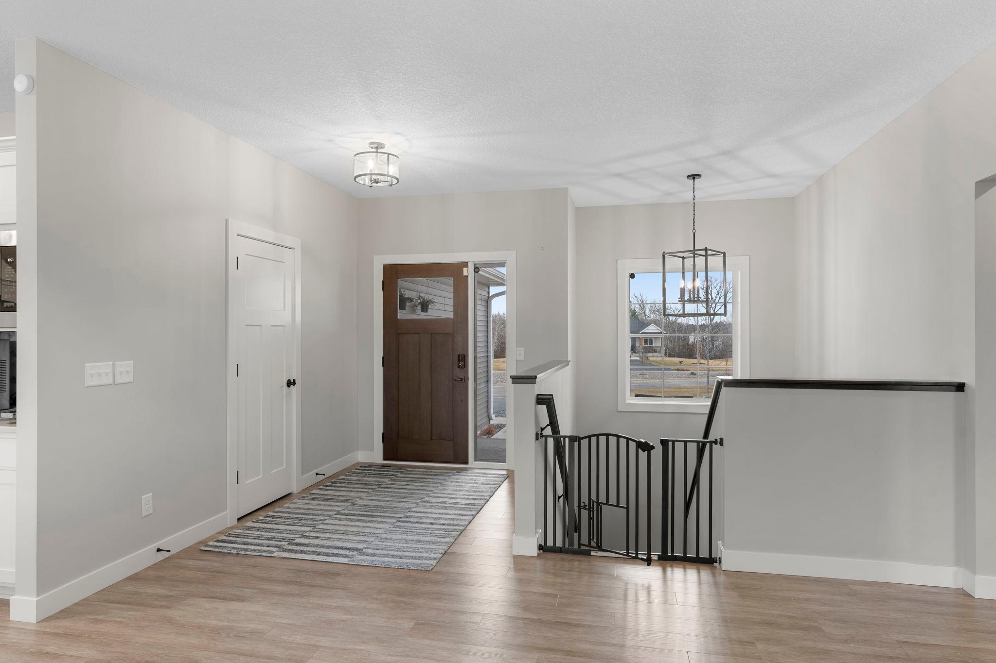 View to main entry door and staircase to lower level.