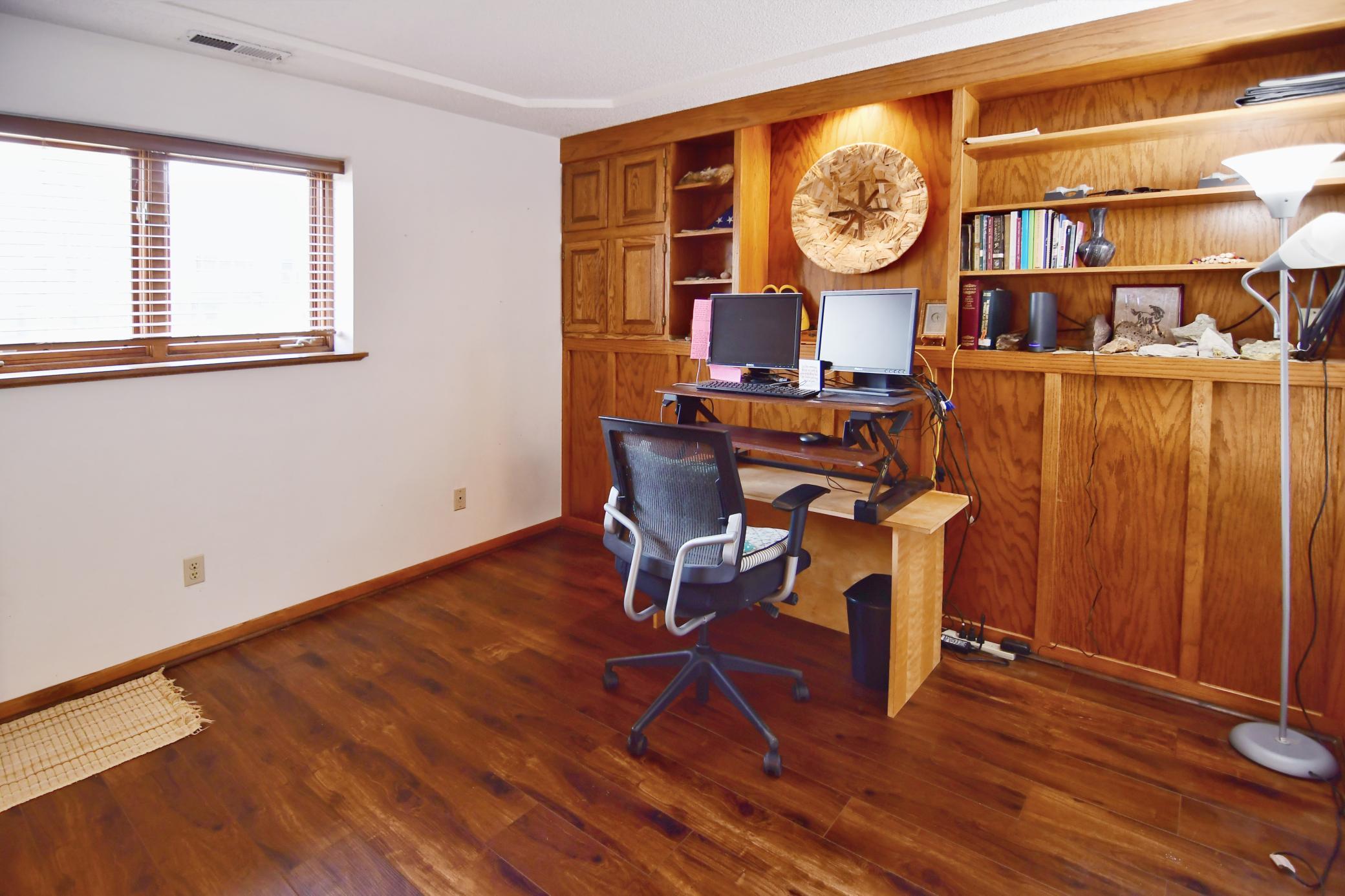 Home office with built-in cabinetry can quickly change to a 3rd bedroom.