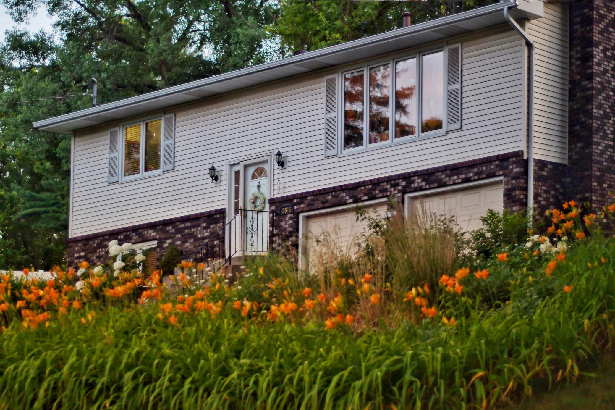 Lilies and hydrangeas, once bloomed, enhance the curb appeal.