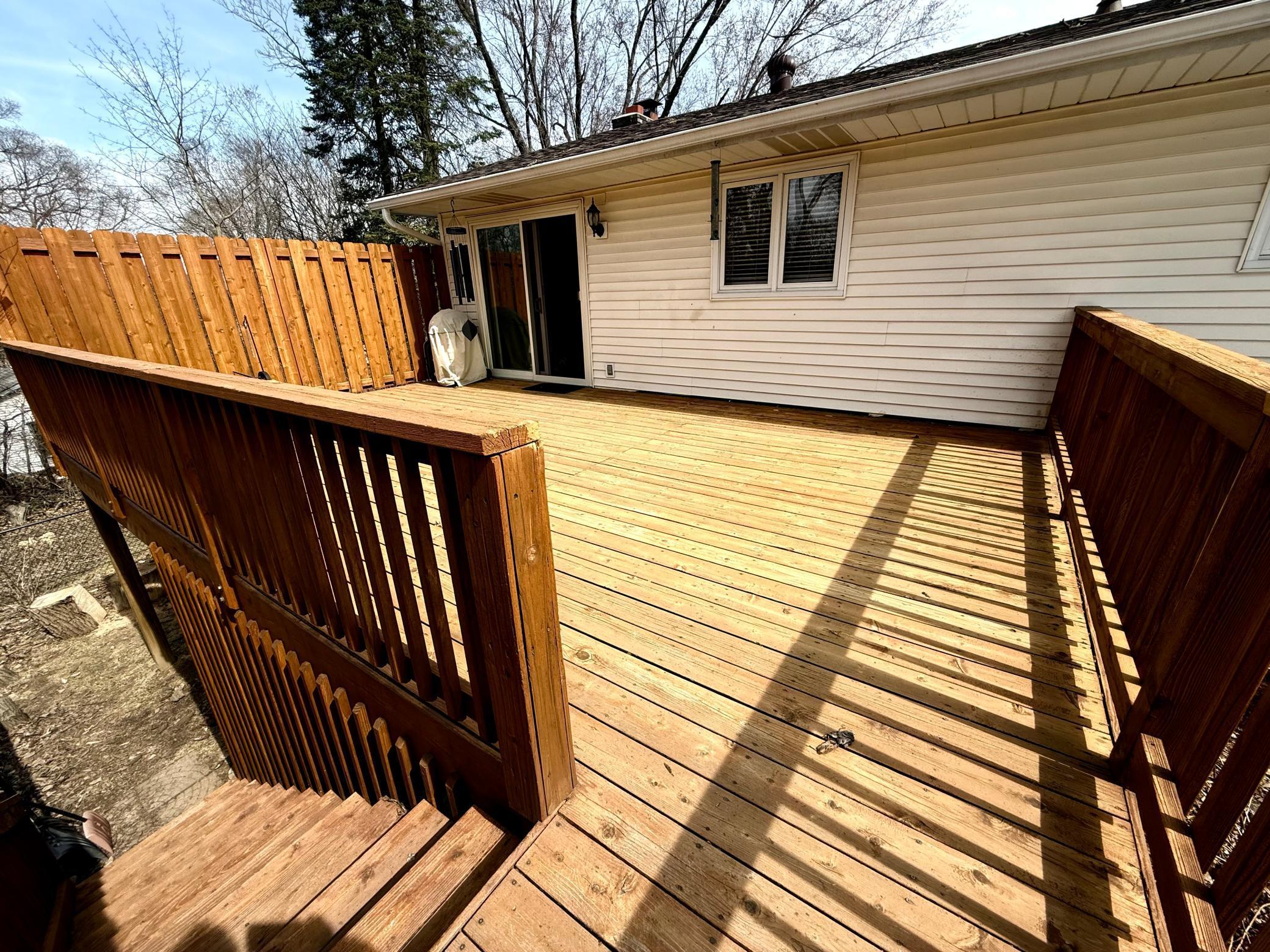 Deck stairs lead to the yard.