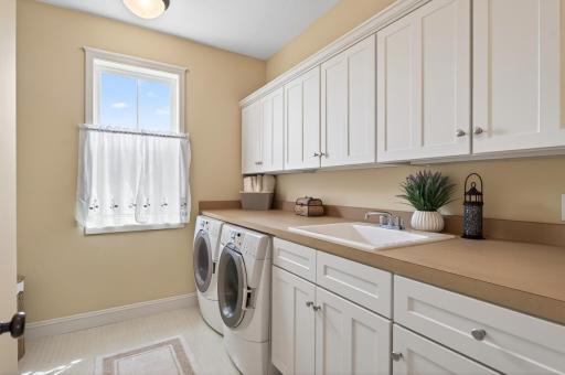 The peak of convenience! This dedicated upper-level laundry room is perfectly situated near the bedrooms. Featuring built-in storage and folding space, it turns a daily chore into an effortless routine