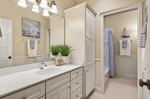 Conveniently located to serve the additional bedrooms, this full bath is designed to handle busy mornings with ease, the space features a large vanity with ample storage and a versatile tub-and-shower combination