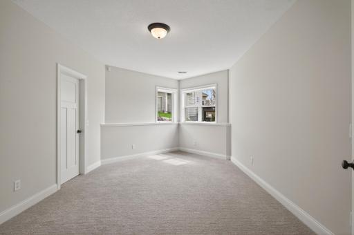 Two additional legal bedrooms feature large egress windows, plush new carpeting, and generous closet space