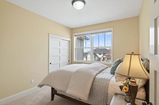 This bright upper-level bedroom offers generous proportions, making it ideal for a secondary primary or long-term guest room