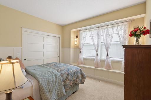 Perfectly positioned for peaceful rest, this charming bedroom features large windows and neutral tones, serving as a blank canvas for a child’s room, hobby space, or secondary home office