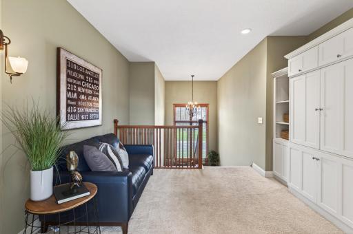 This versatile loft area serves as a cozy perfect space for a quiet reading nook, a peaceful media retreat, or an intimate gathering spot
