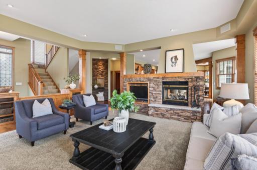 Expansive living room anchored by a striking stone fireplace and designed for elevated everyday living