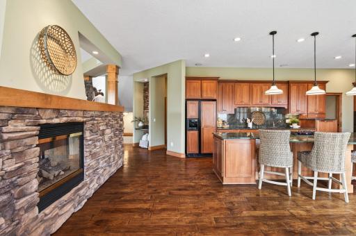 Stone textures, warm woods, and natural light, ample storage with natural cabinetry and a built-in refrigerator and dishwasher