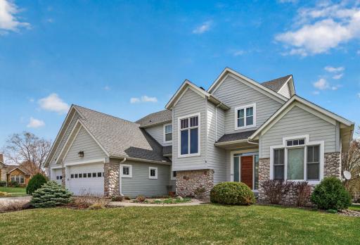 Exceptional curb appeal with its charming stone accents, inviting entryway, and thoughtfully designed landscaping, all complemented by a spacious and well-maintained exterior
