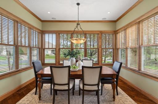 Expansive windows flood the room with natural light, while the statement chandelier adds a touch of character and ambiance