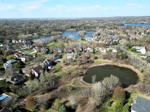 Stunning aerial views highlight a peaceful neighborhood integrated with nature. Enjoy a prime location surrounded by scenic ponds, mature trees, and beautiful community vistas