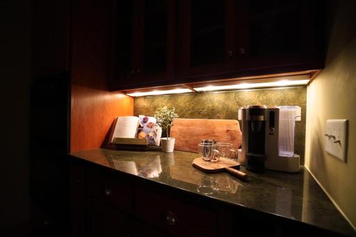 Under-cabinet lighting casts a gentle glow across the countertops