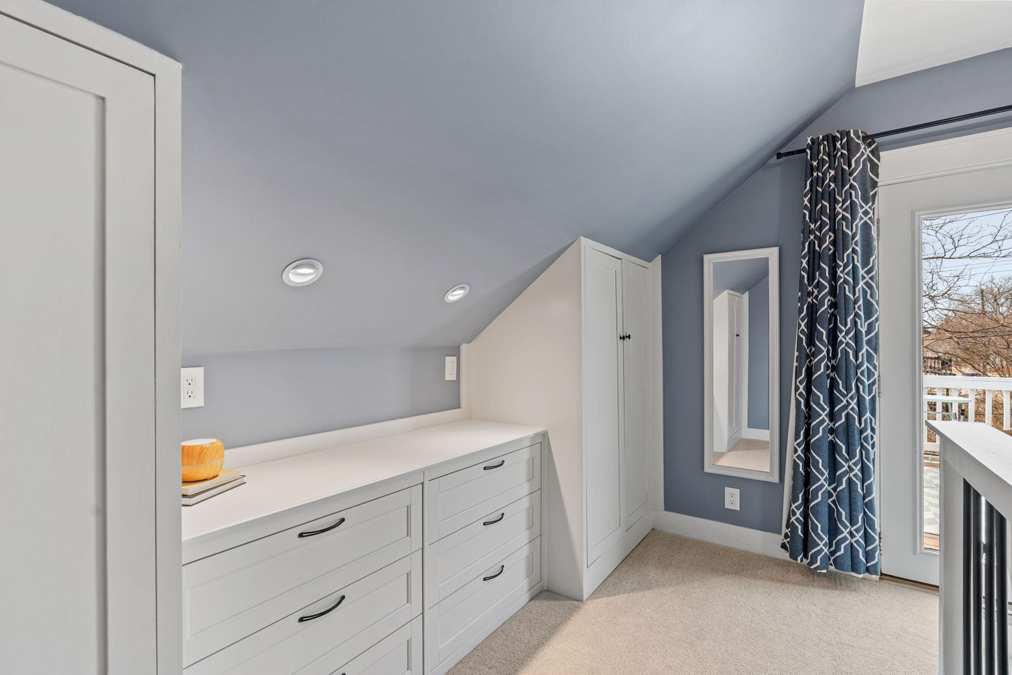 Both sides of the stairwell features built-in closets and drawers