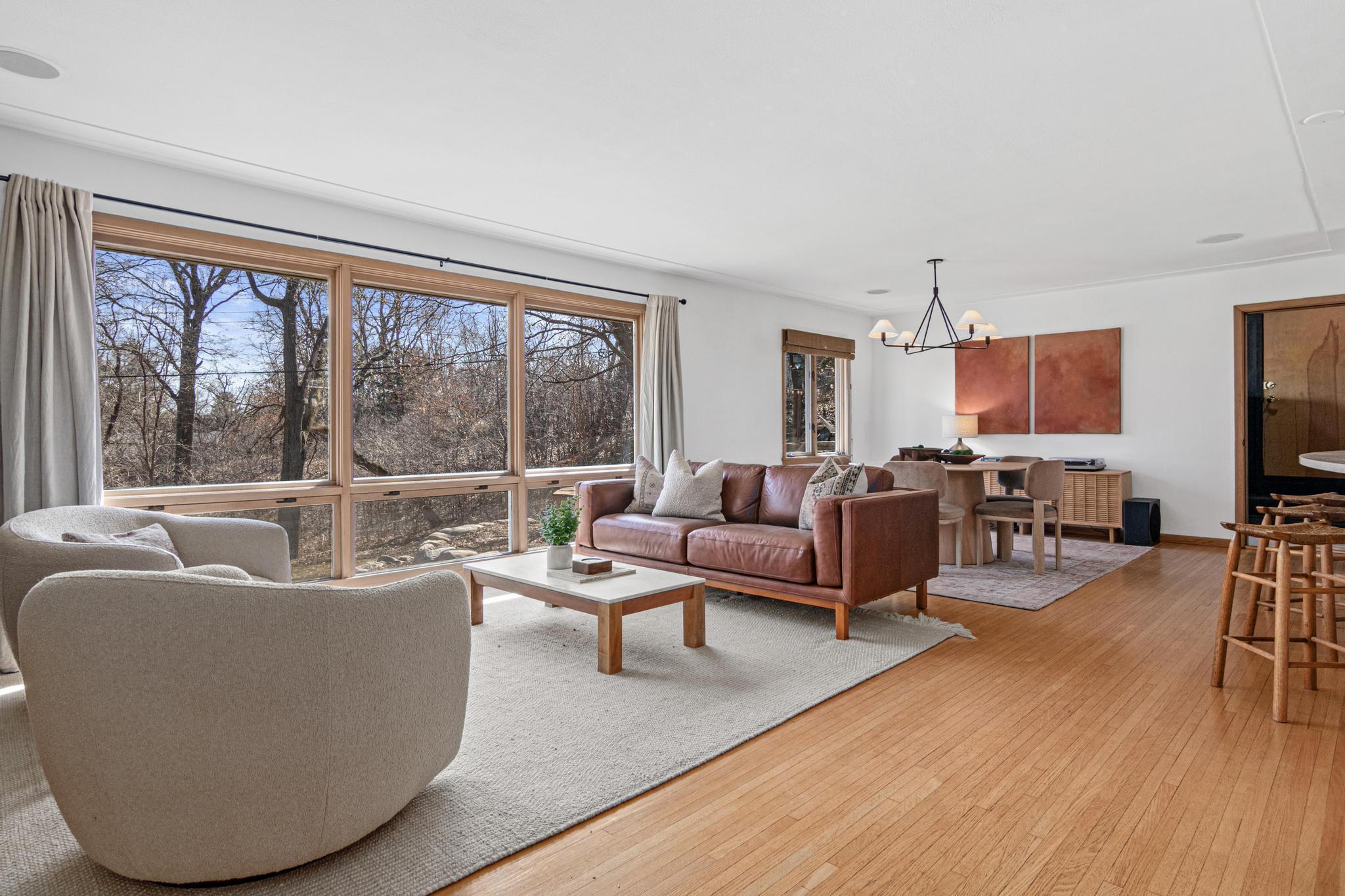 Floor-to-ceiling windows bring the treetop canopy indoors, a living, shifting backdrop that changes with the light, the season, and the weather.