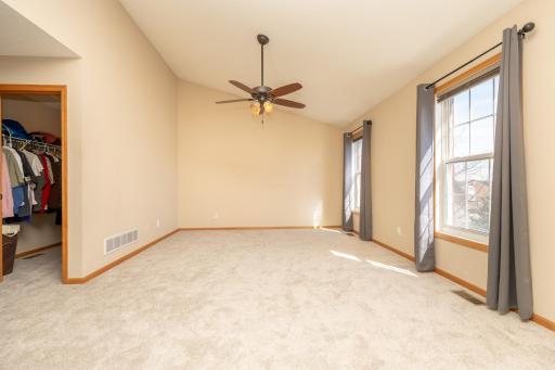 Primary bedroom (upper level) with vaulted ceilings and tons of natural light