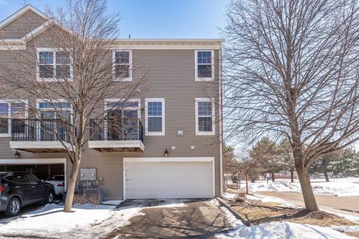 2 car garage with green space next to it