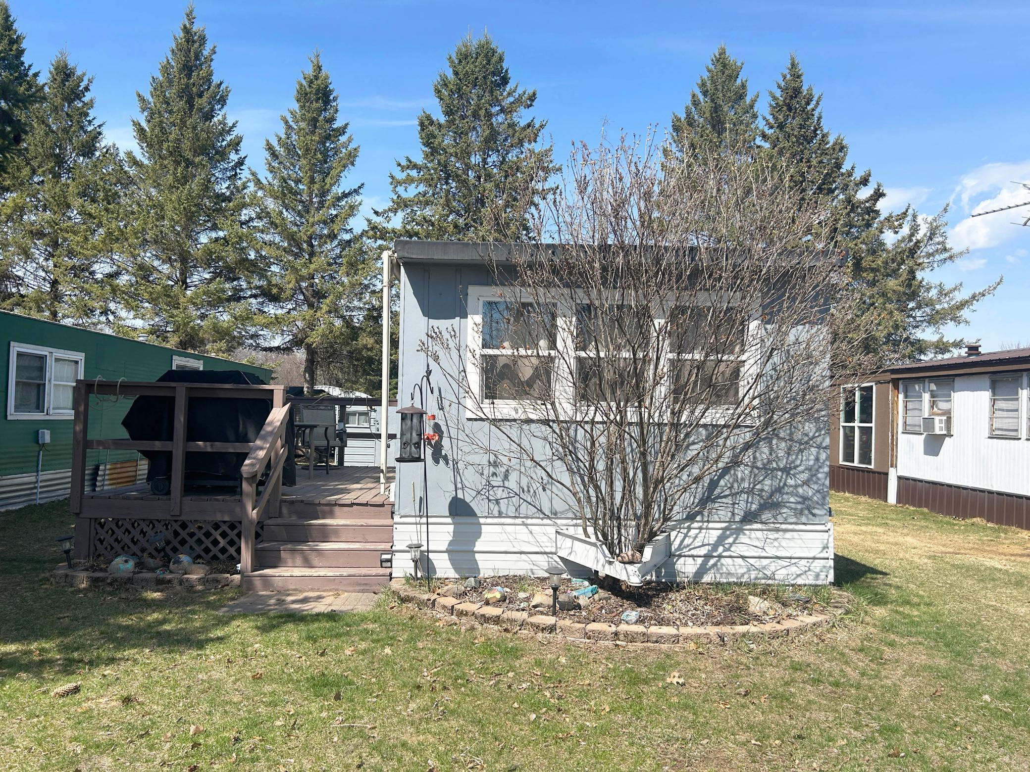 Another exterior shot, featuring the home, landscaping and deck.
