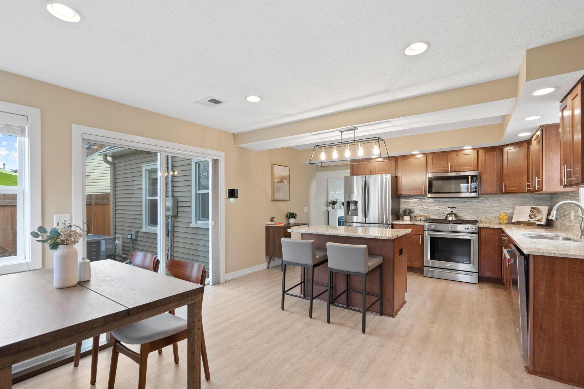 Two doors leading to the backyard: slider door leading to paver patio and a back door leading to backyard/back porch.