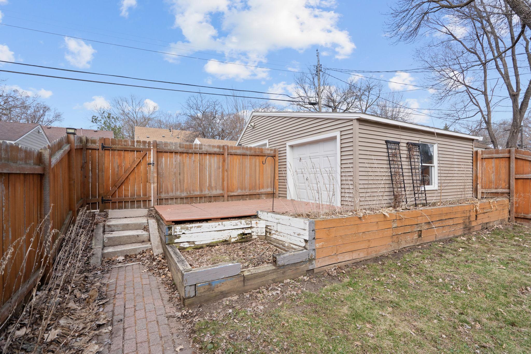Garage can accommodate 2 cars. You just need to remove part of the fence and the current platform deck.