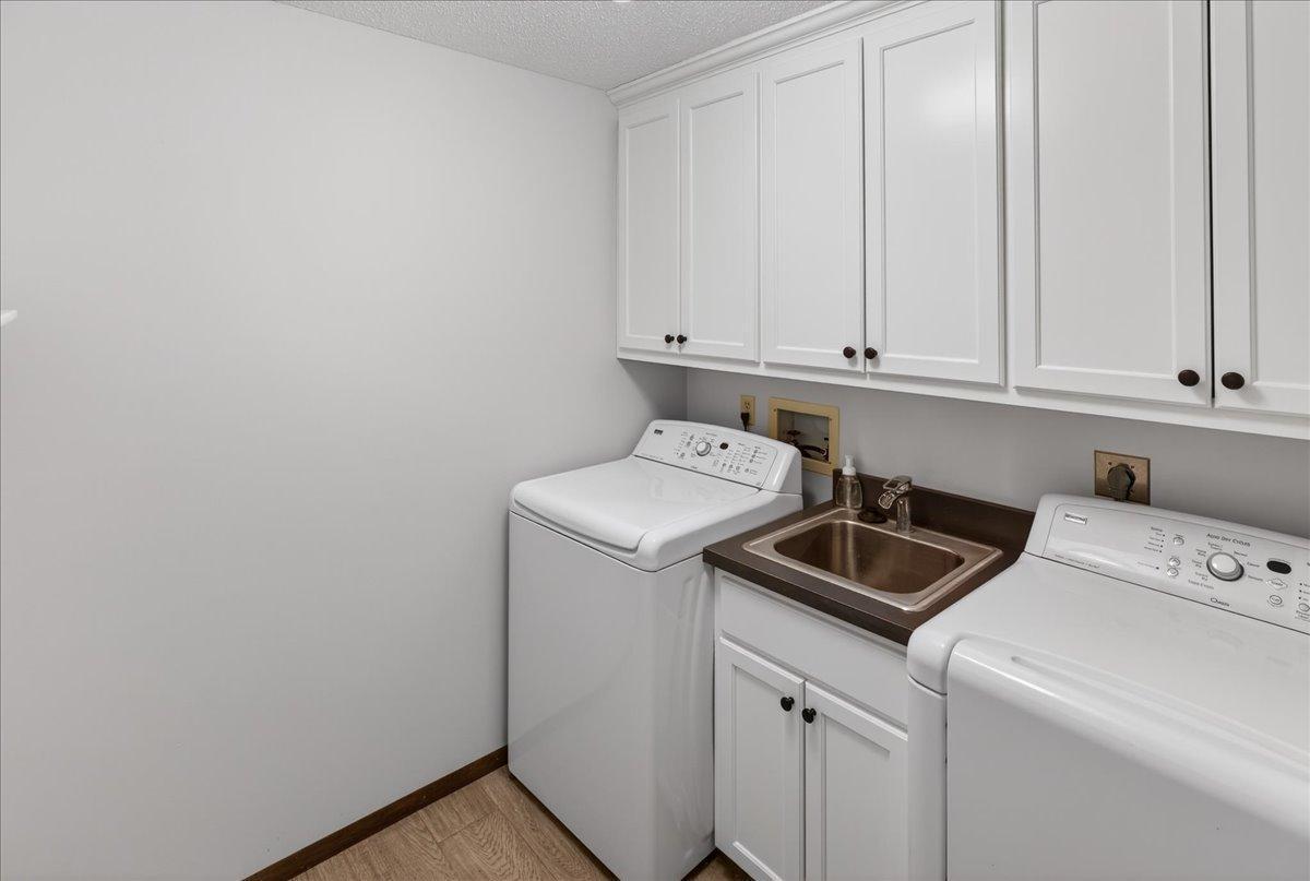 Laundry Room with custom upper cabinets and utility sink