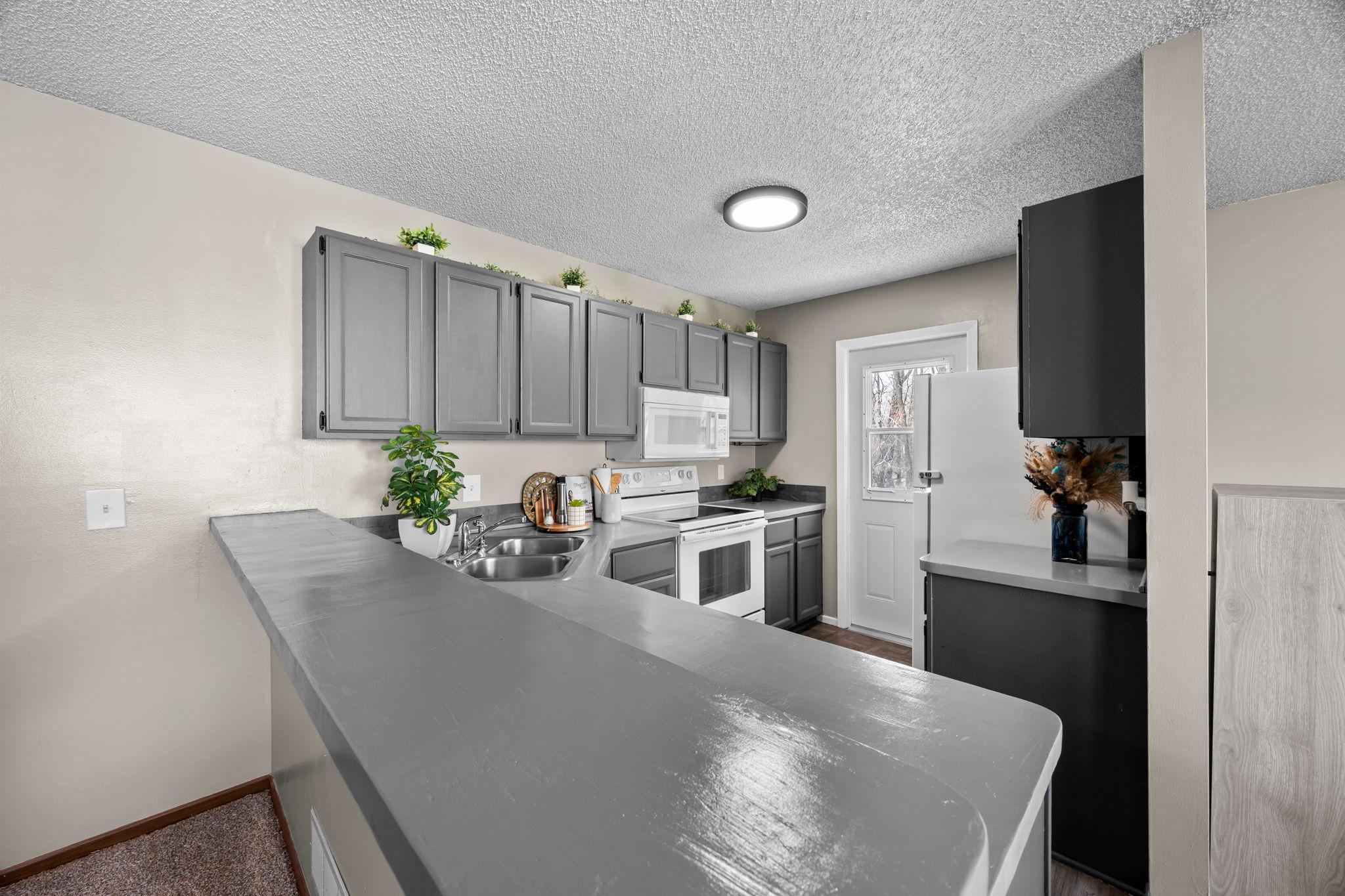 Bright kitchen with balcony door adding sunlight