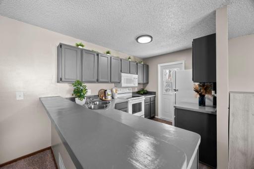 Bright kitchen with balcony door adding sunlight