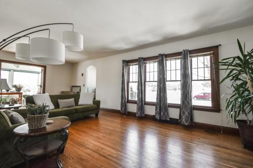 The natural woodwork and charm of the entryway arch is showcased in the large living.