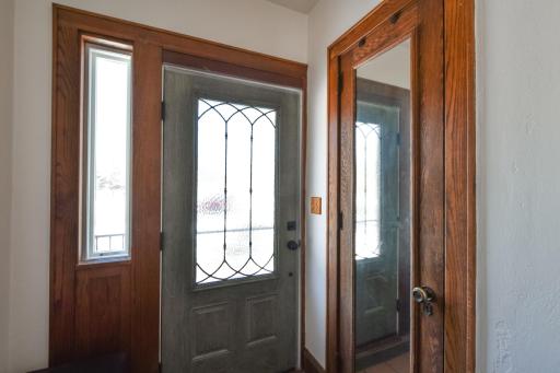 Main house front entry area with a storage closet and new steel door and storm door.