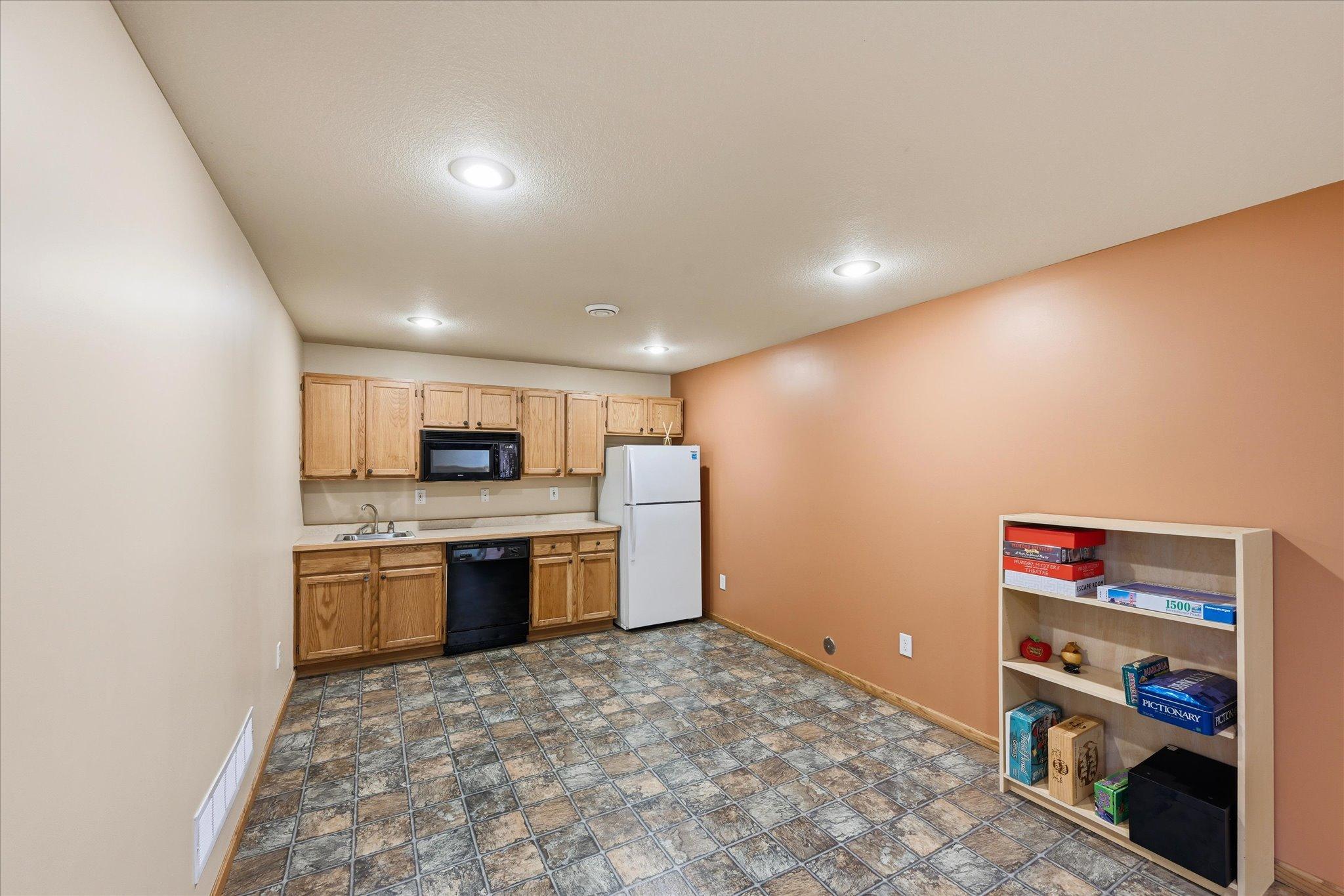 Convenient lower-level kitchenette adds flexibility for entertaining