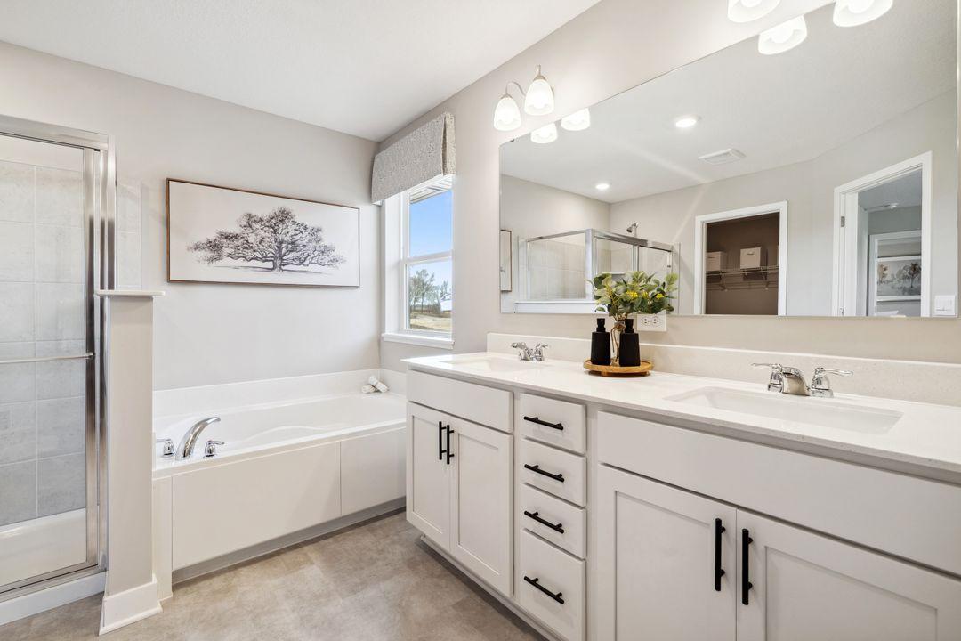 The primary bathroom features dual sinks, and both a shower and soaking tub for the ultimate relaxation. No need to share a closet, there are TWO!