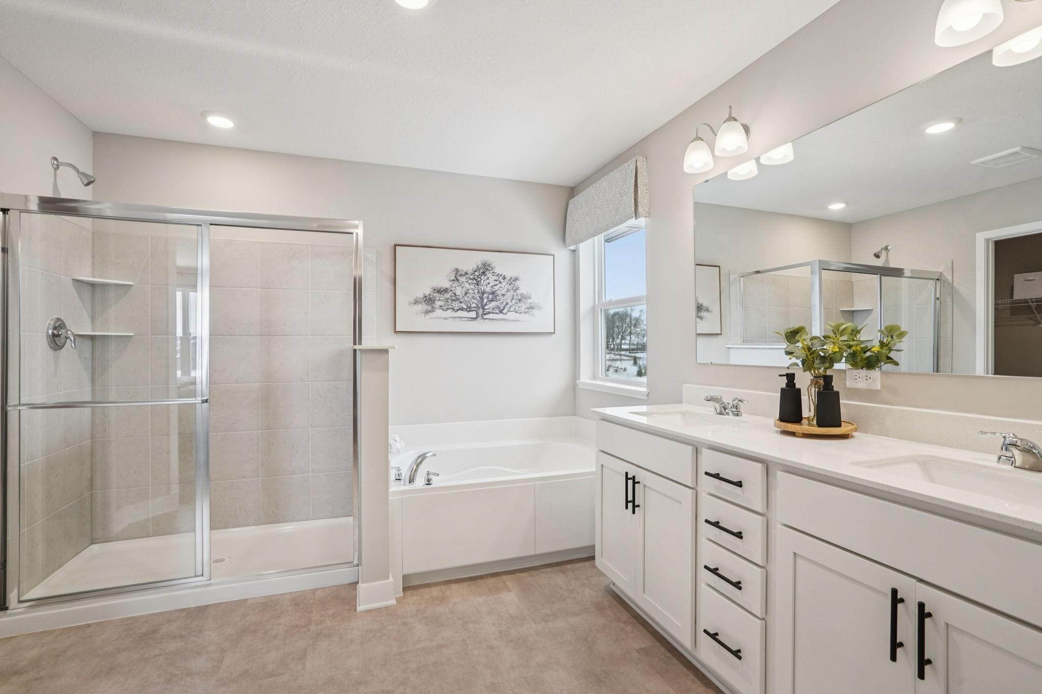 The primary bathroom features dual sinks, and both a shower and soaking tub for the ultimate relaxation. No need to share a closet, there are TWO!