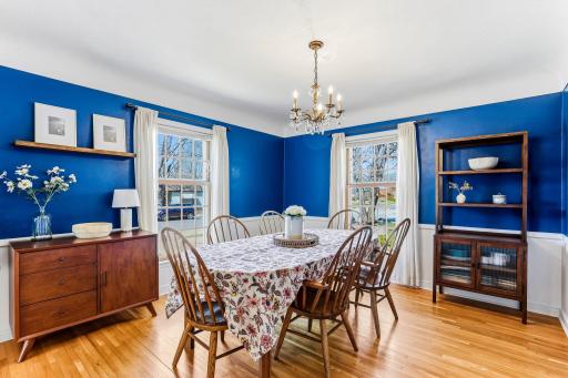 Formal dining room continues original hardwood flooring, a graceful curved ceiling, and classic plaster wallsâblending timeless character with elegant architectural detail.
