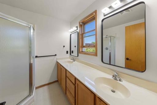 Upper level owner's suite 3/4 private bathroom with double sink vanity