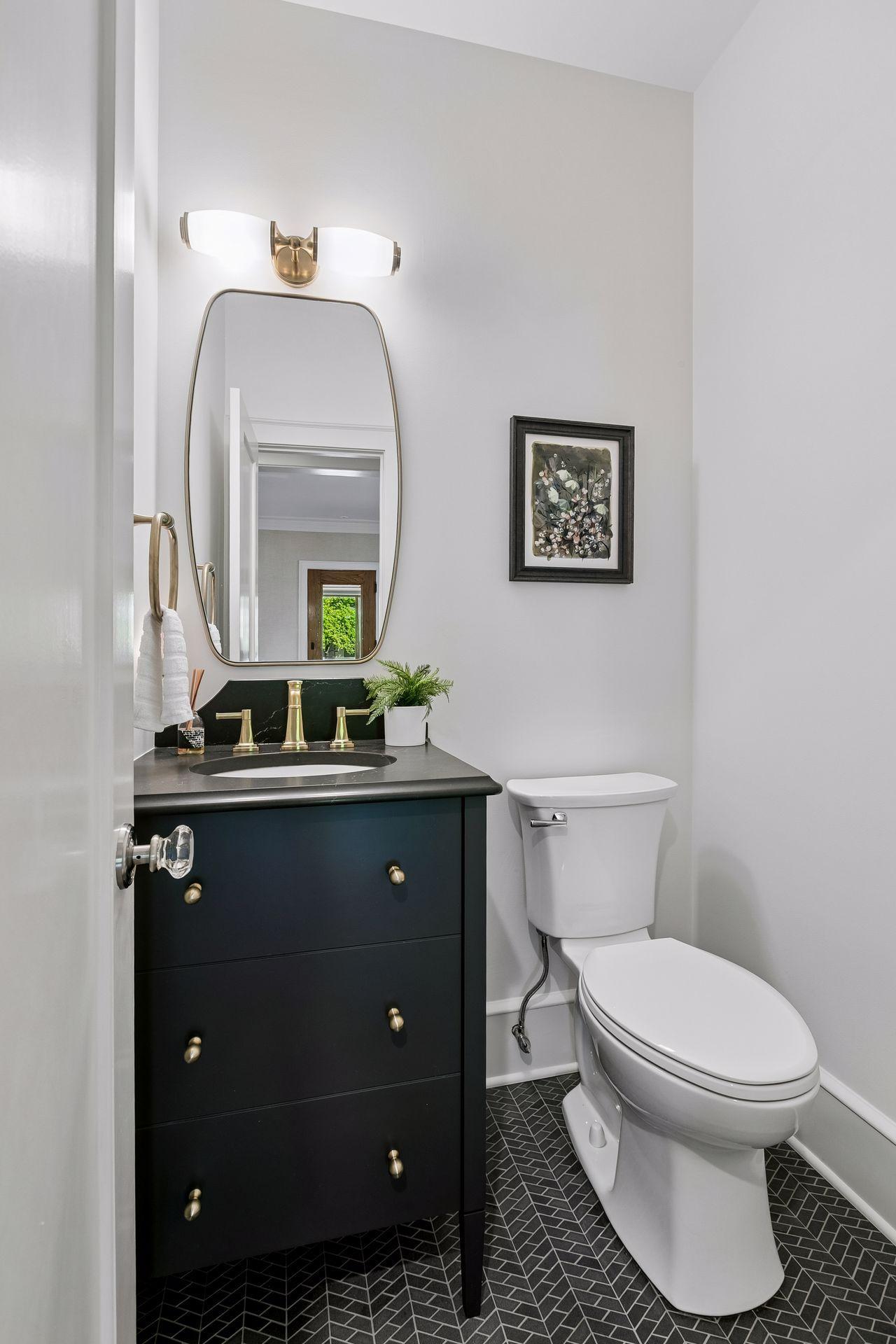 Main floor powder room with a new tile floor
