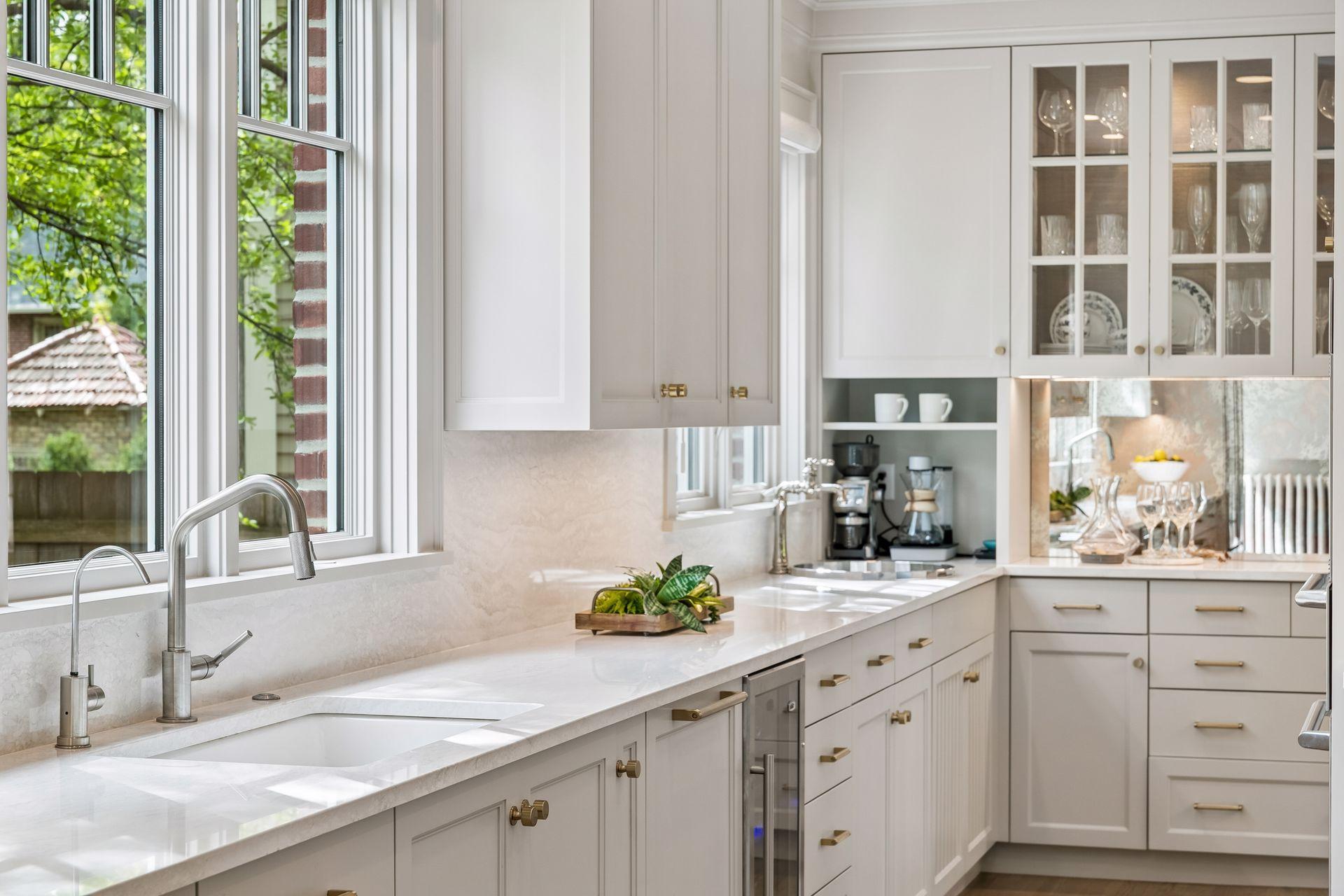 New bar sink, wine refrigerator and custom built hutch created a bar area. Illuminated cabinets provide a place to display your favorite things.