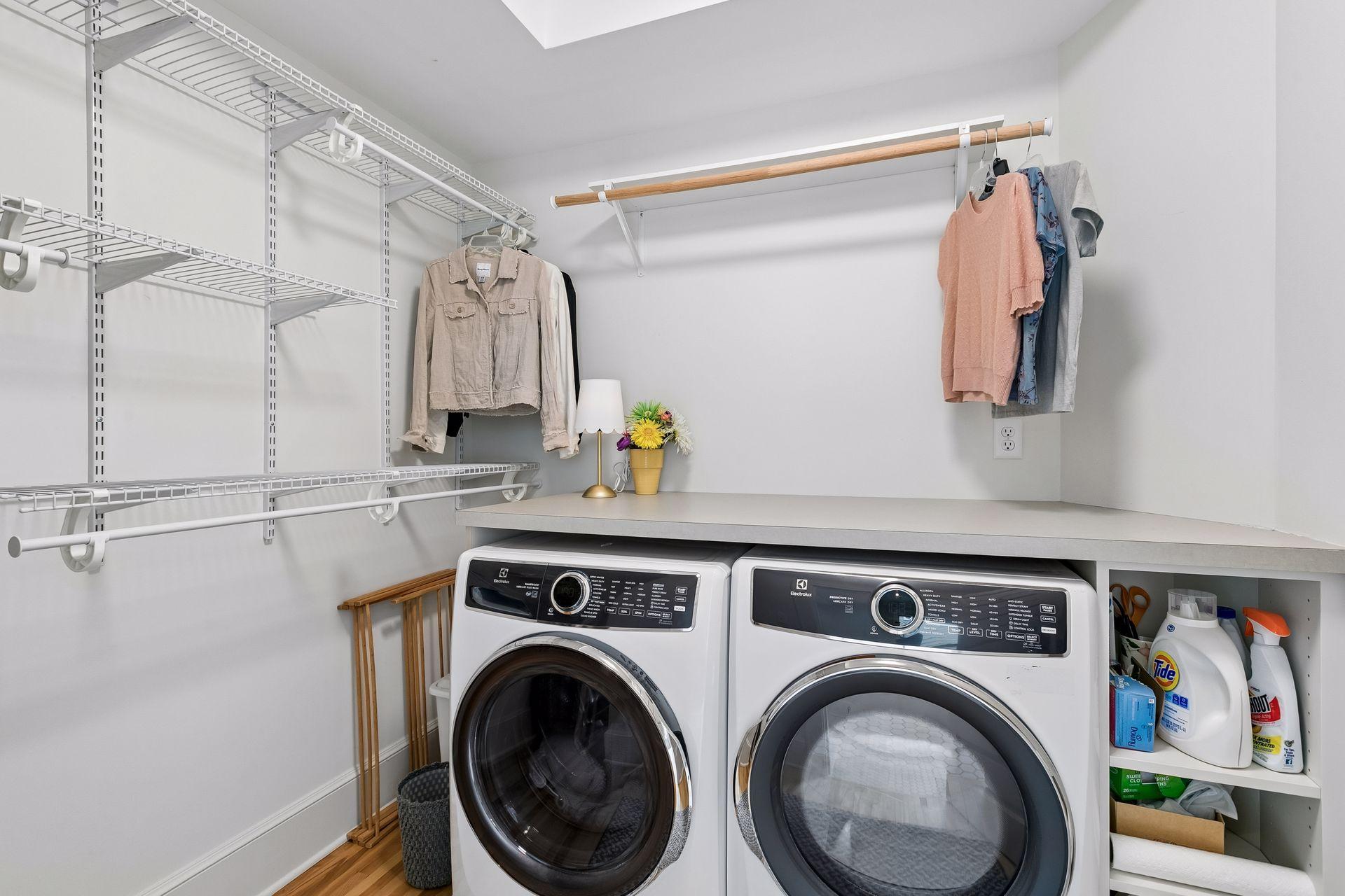 The large walk- in closet provides space for an electric washer and dryer.