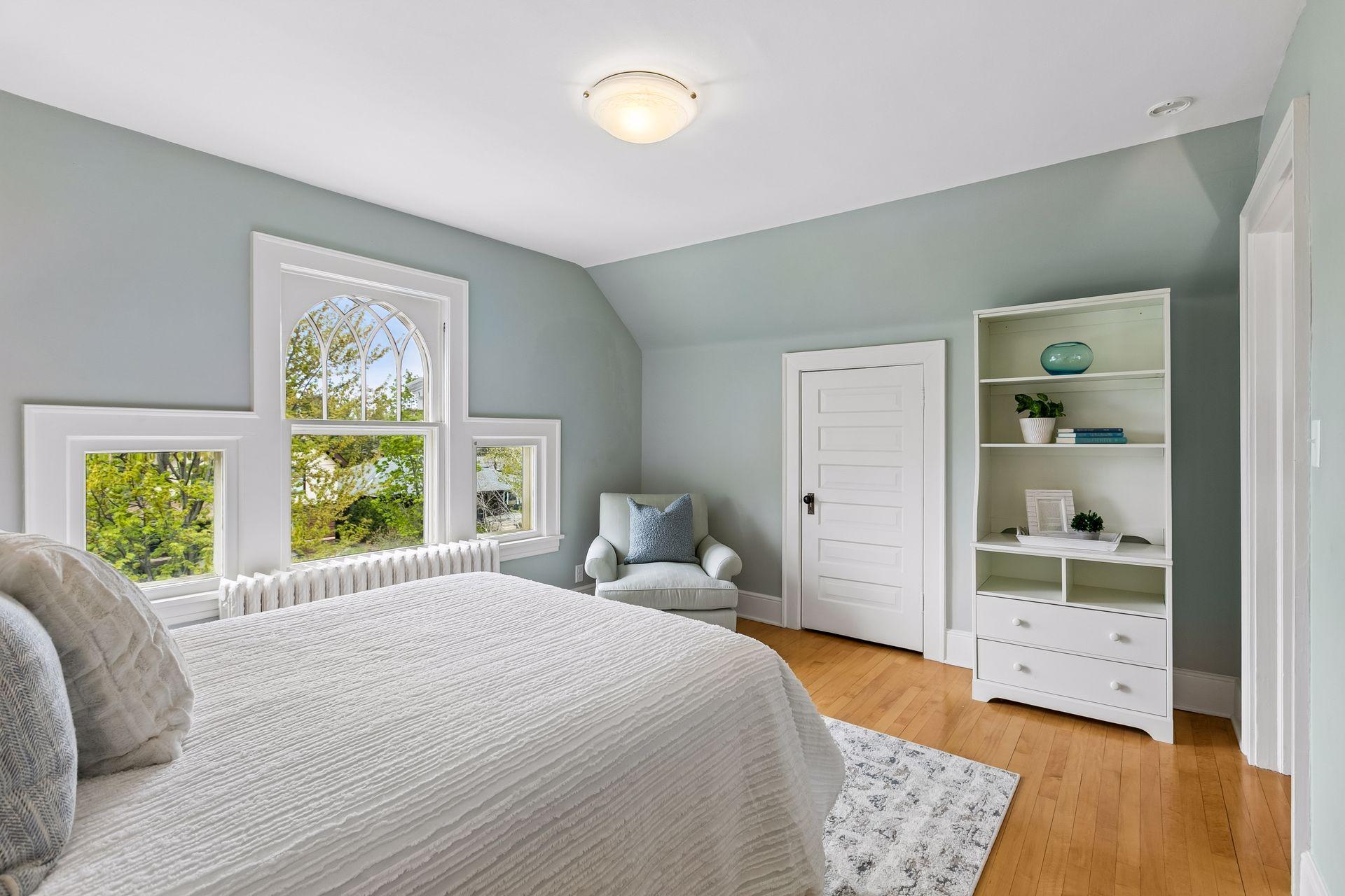 Bedroom 5 with original millwork and windows.
