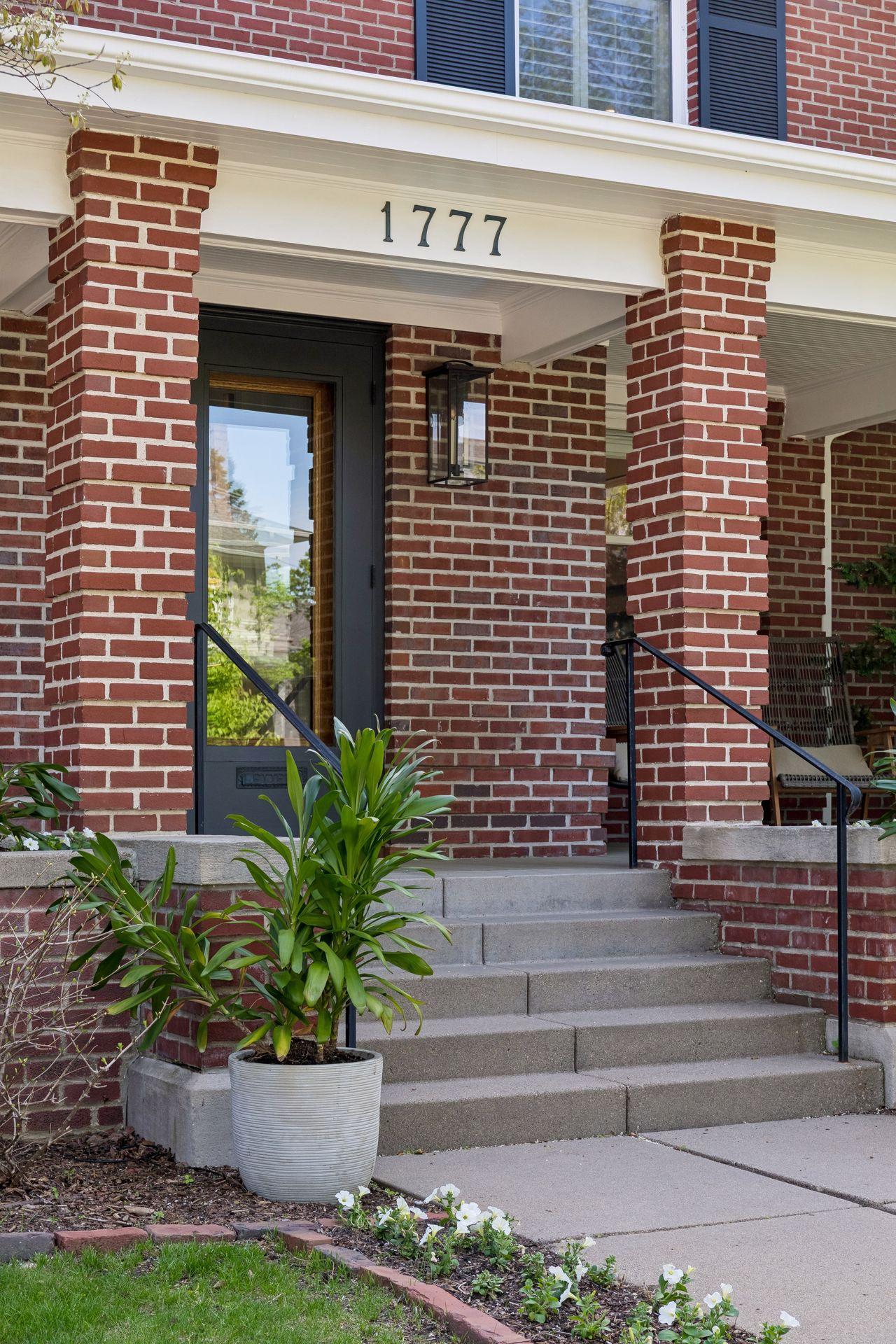 Steps to the front door and porch. Note the mail drop in the original front door.